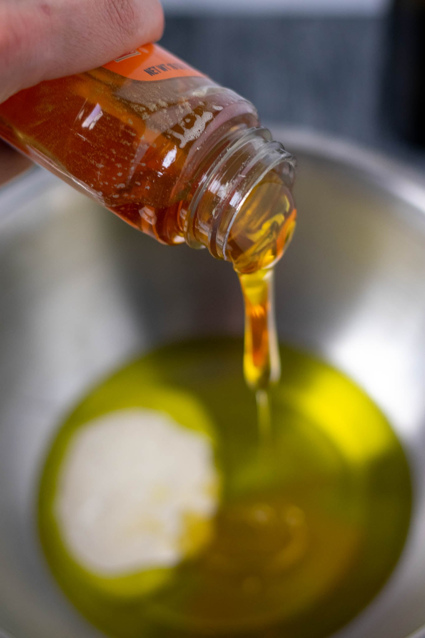 Pouring honey into wet ingredients