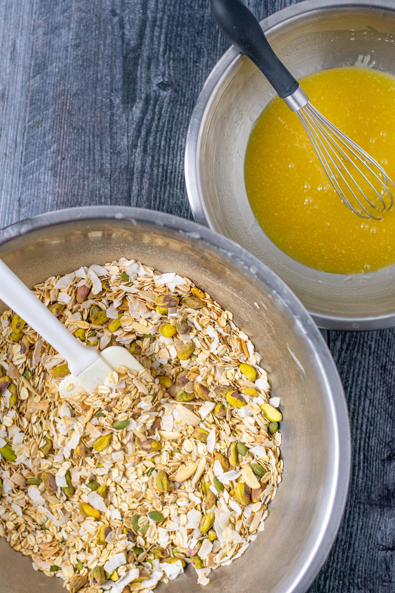 Overhead of large mixing bowl of dry ingredients and smaller mixing bowl of liquid ingredients