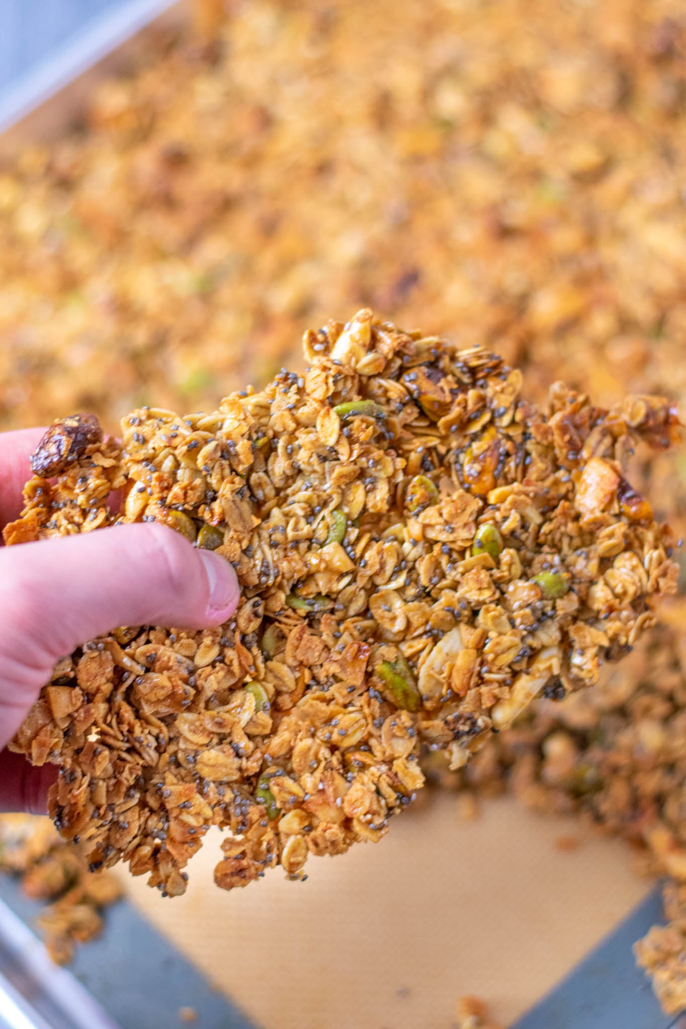 Hand holding large sourdough discard granola cluster