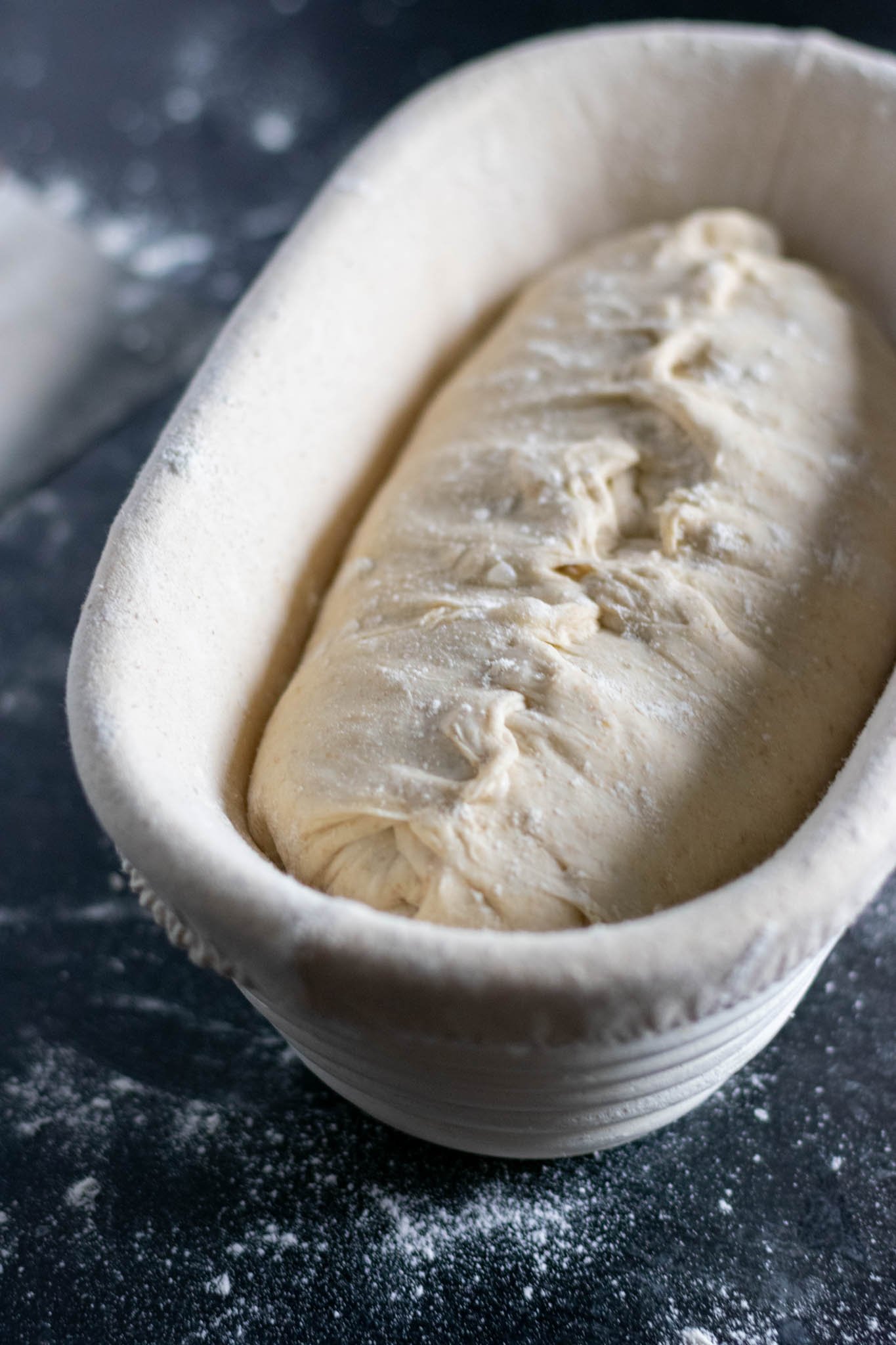 Dough stitched in banneton before going into refrigerator for overnight proof