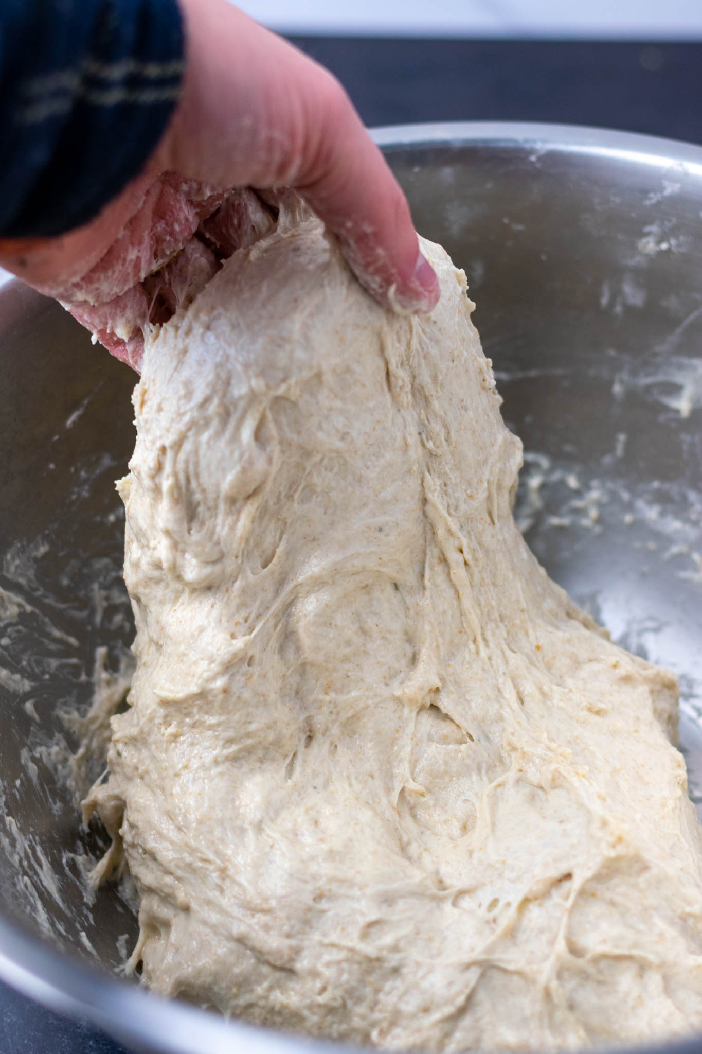 https://sourdoughbrandon.com/wp-content/uploads/2022/02/Mixing-dough-after-adding-levain.jpg