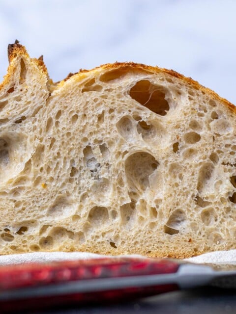 My everyday sourdough bread crumbshot sliced with open crumb and bread knife
