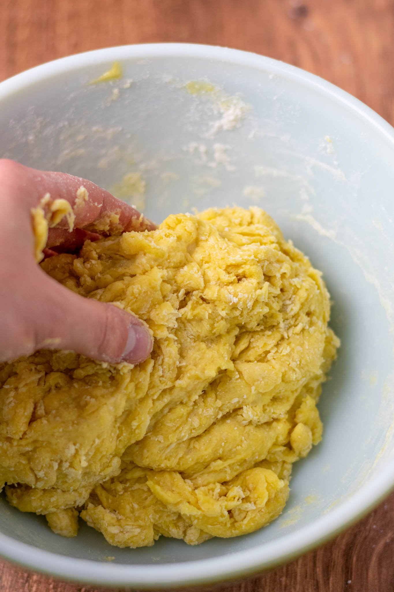 Hand further mixing the dough so less flour pockets remain