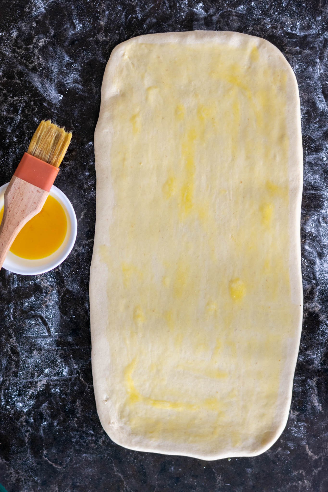 Dough rolled out on counter with egg wash applied