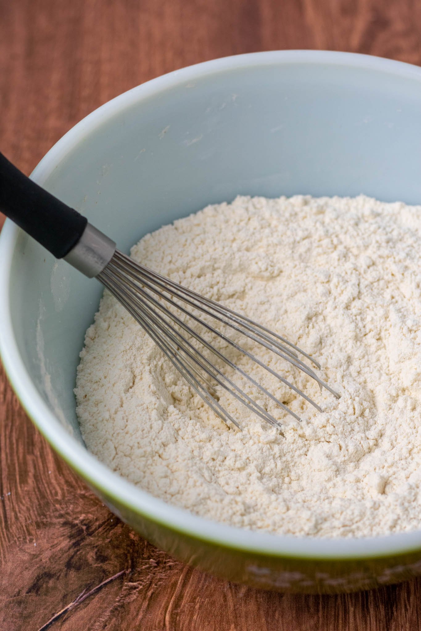 Mixing dry ingredients for sourdough challah in bowl