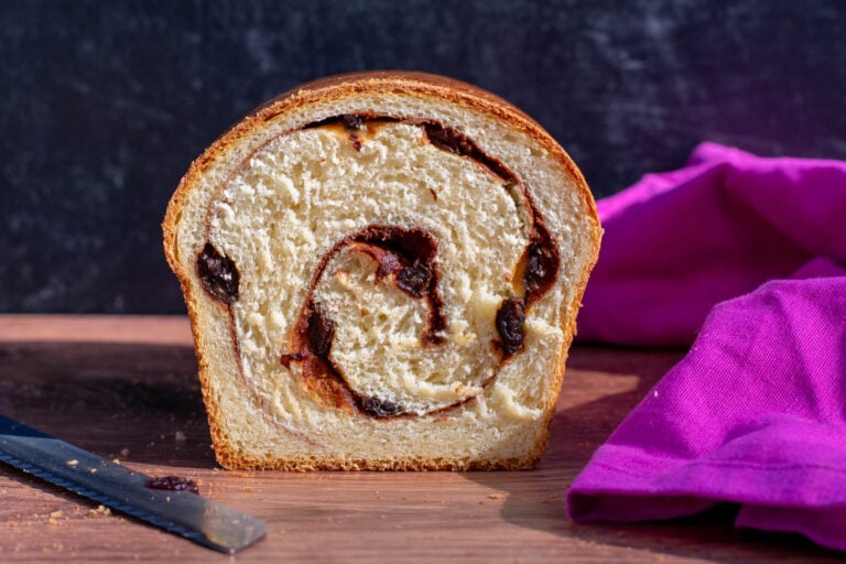 Landscape crumbshot of sourdough cinnamon raisin swirl swirl bread with bread knife