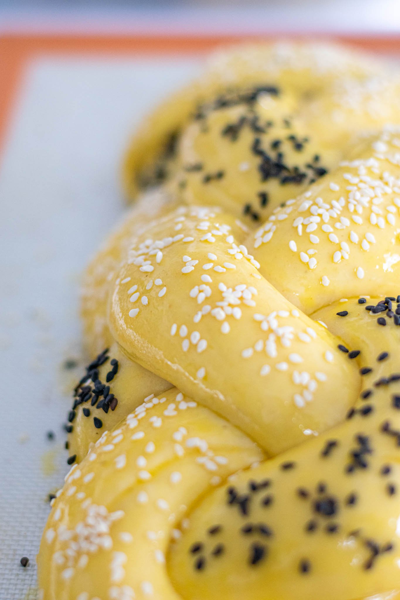 Up close sourdough challah with egg wash and sesame seeds