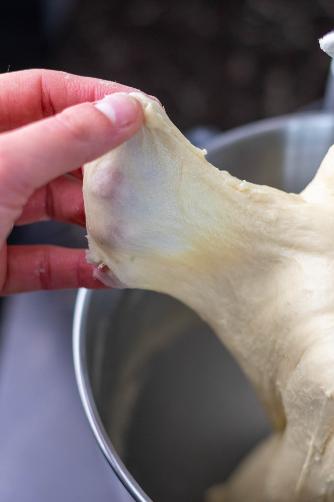Hand stretching dough for windowpane test