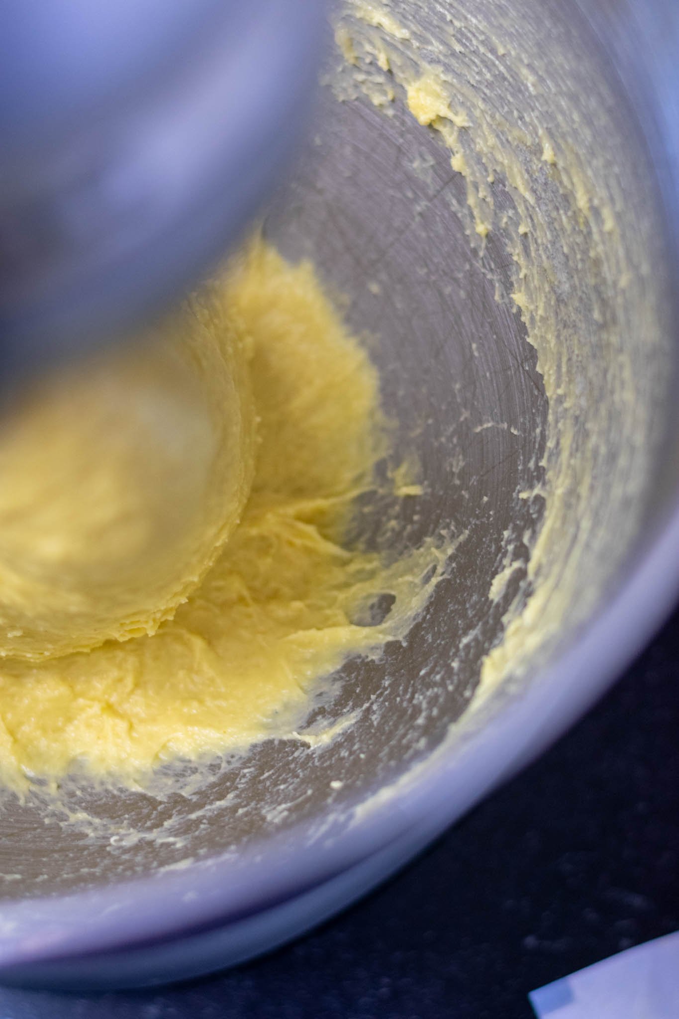Brioche dough in mixing bowl clearing sides of bowl