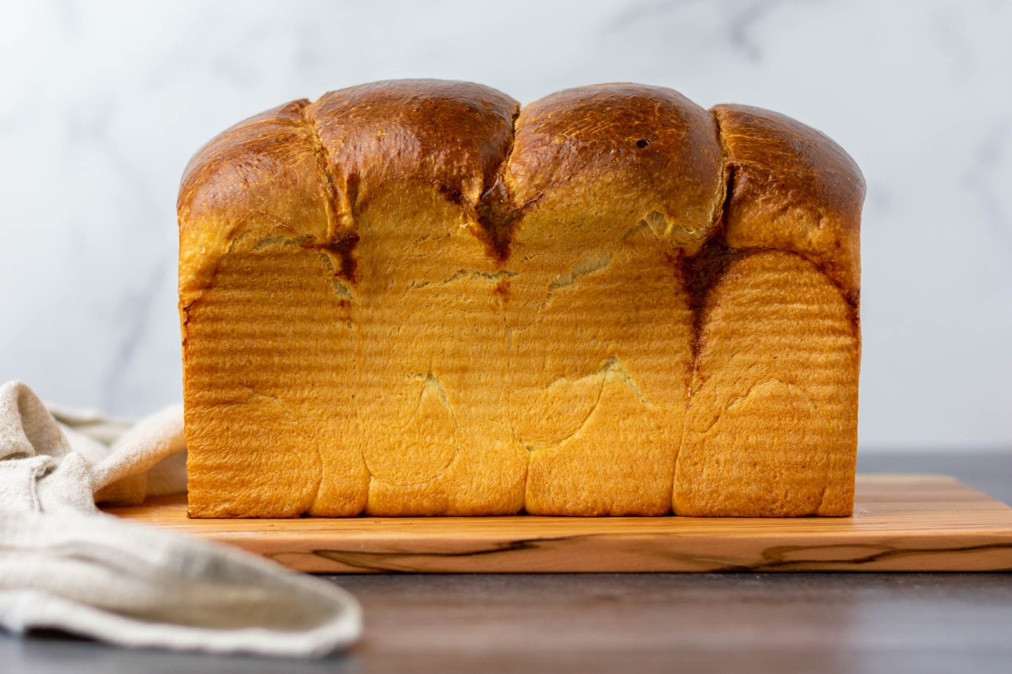 Baked sourdough brioche loaf from side