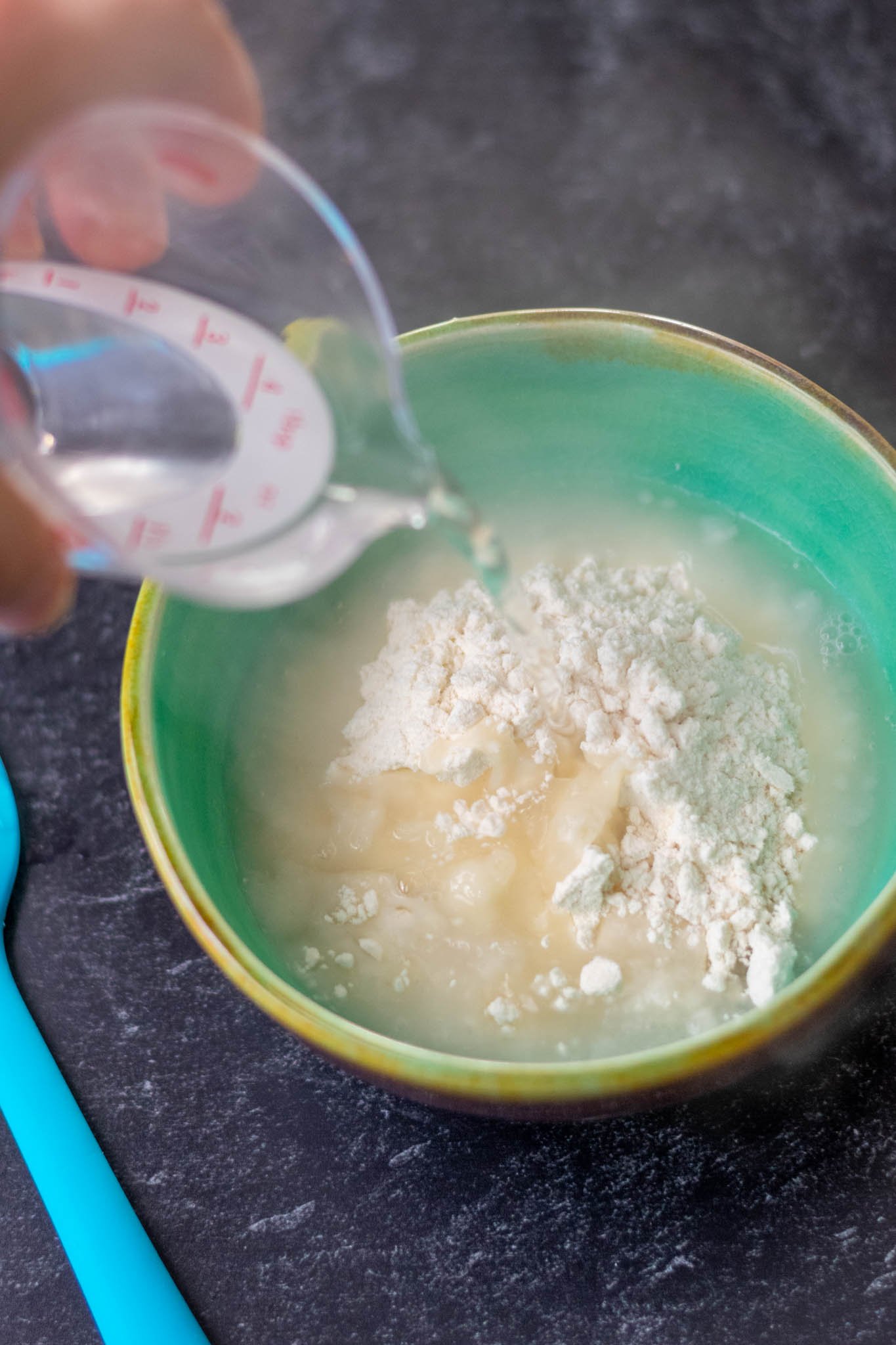 Pouring boiling water into flour bowl for yudane
