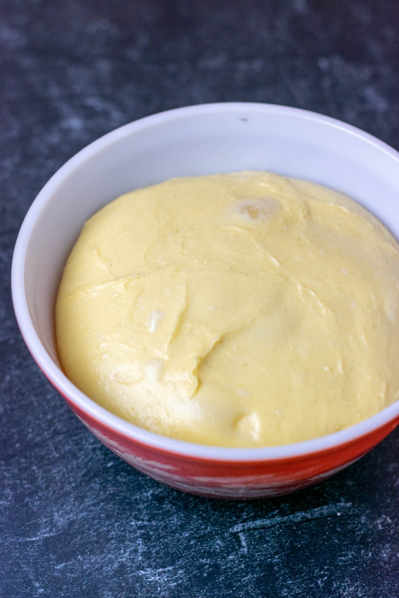 Proofed brioche dough in bowl