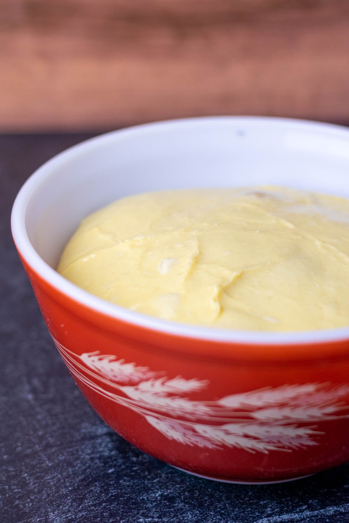 Proofed brioche dough in bowl