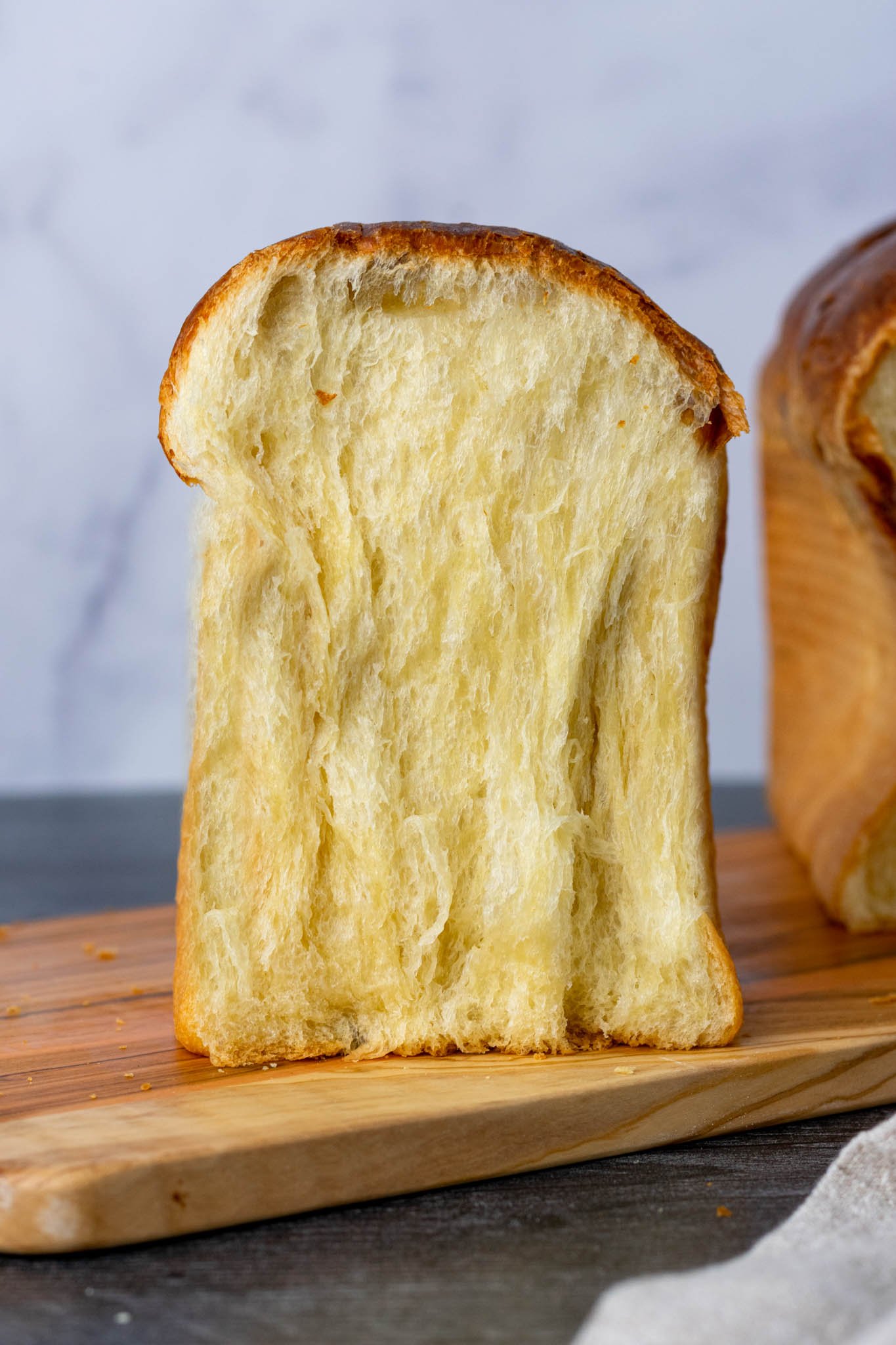 Crumbshot of a slice of tall sourdough brioche