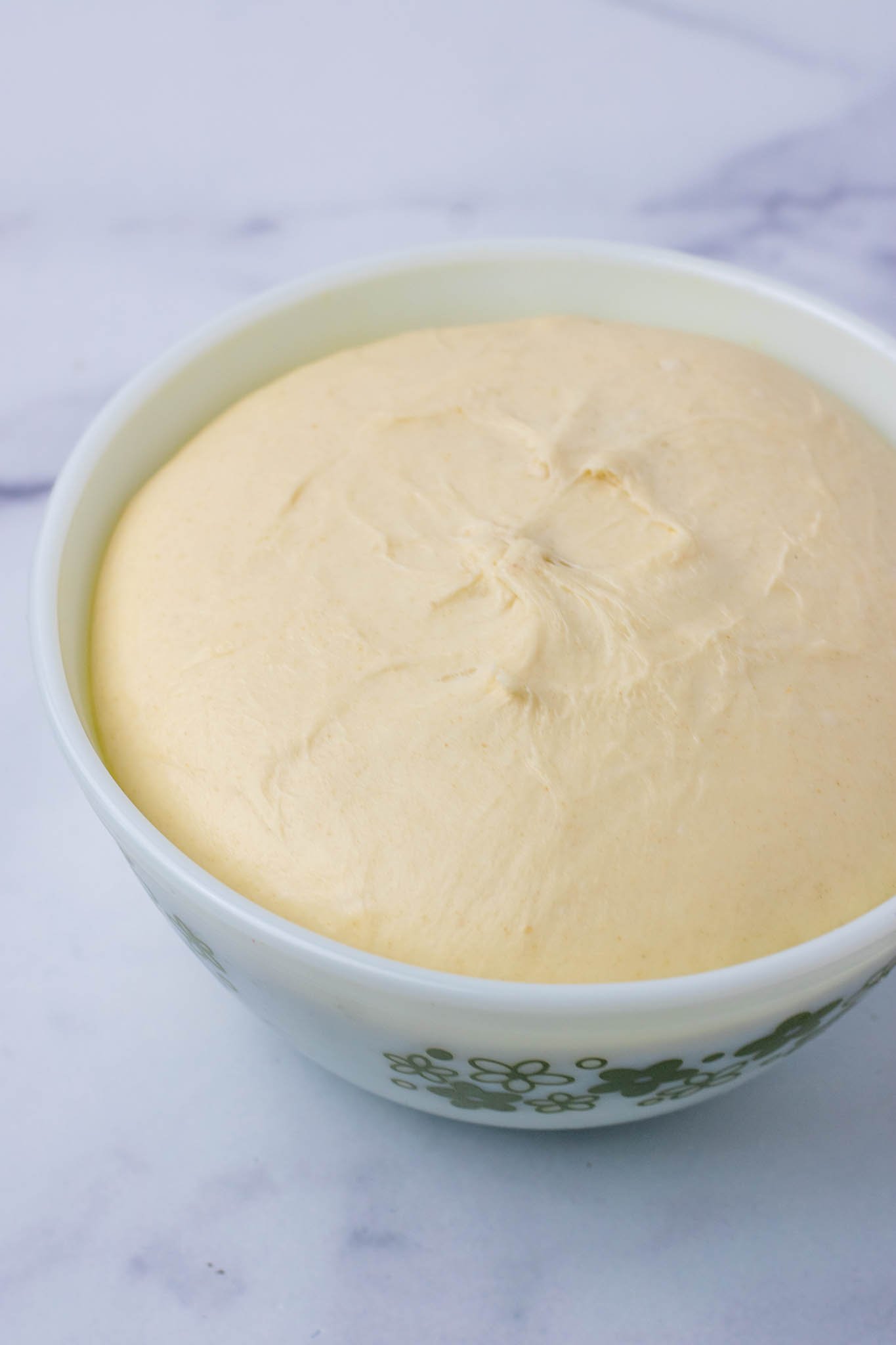 Sourdough sandwich bread dough in bowl at end of bulk fermentation