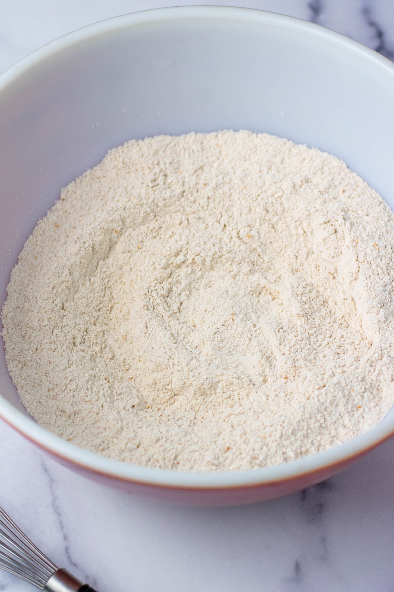Mixed and whisked dry ingredients for scones in bowl