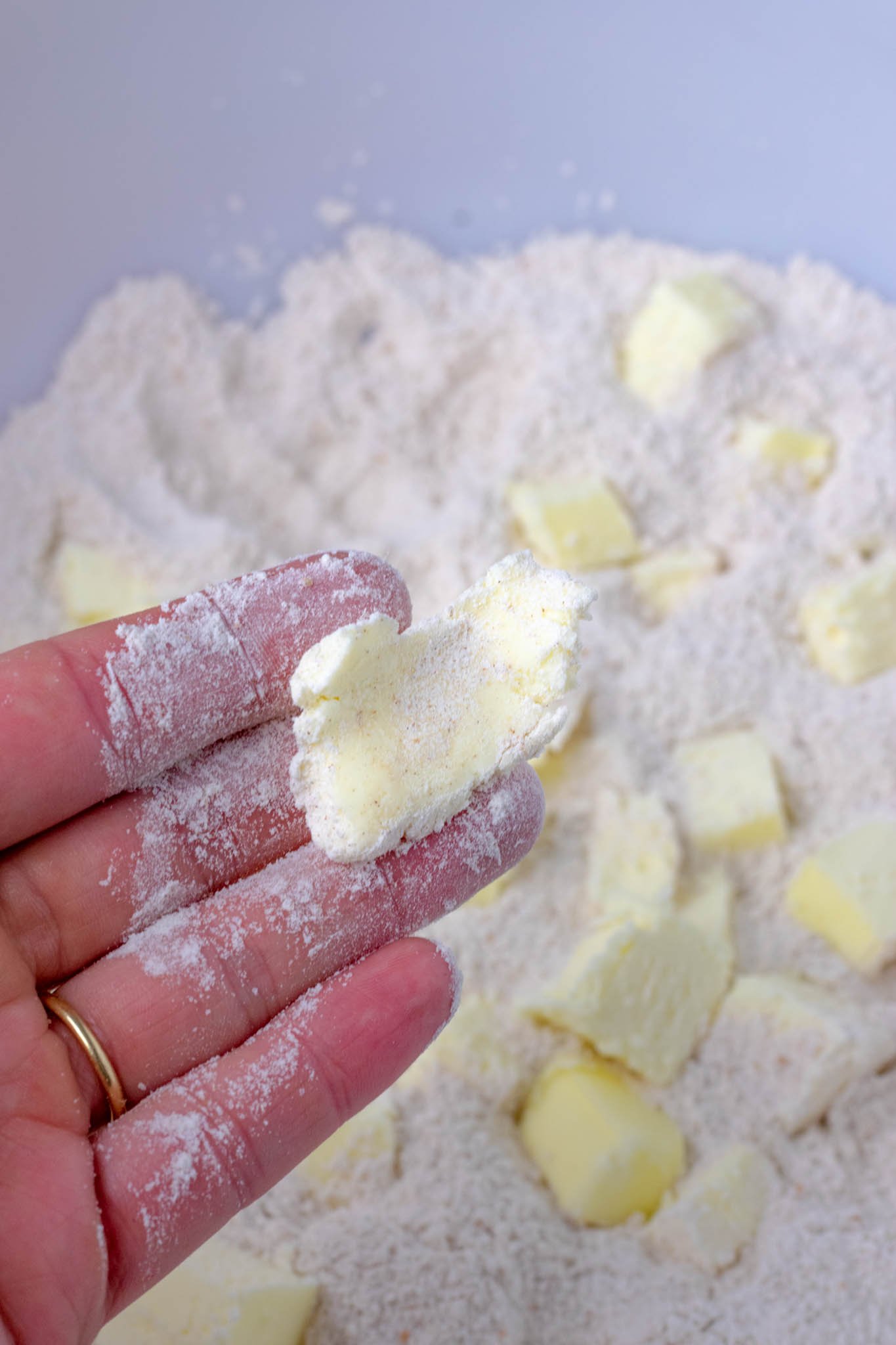 Hand holding smashed piece of butter and flour together