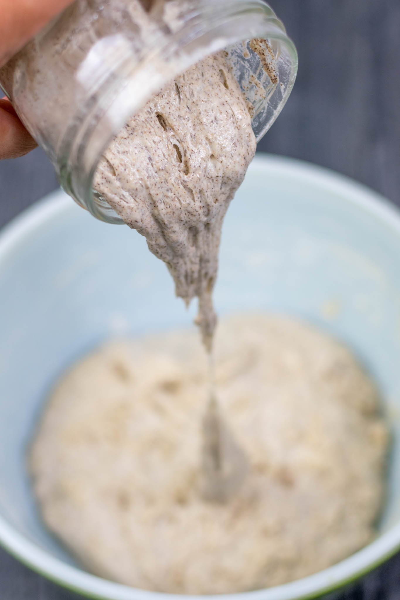 Pouring buckwheat sourdough starter levain from jar into bowl