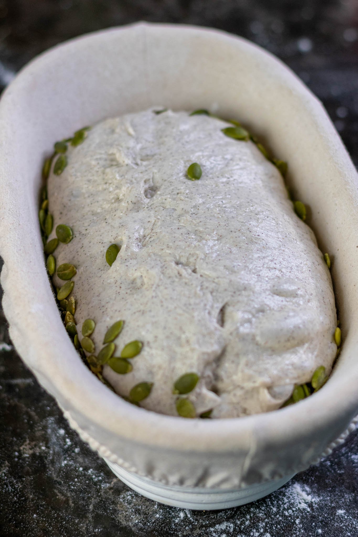 Buckwheat sourdough with pumpkin seeds in oval banneton basket