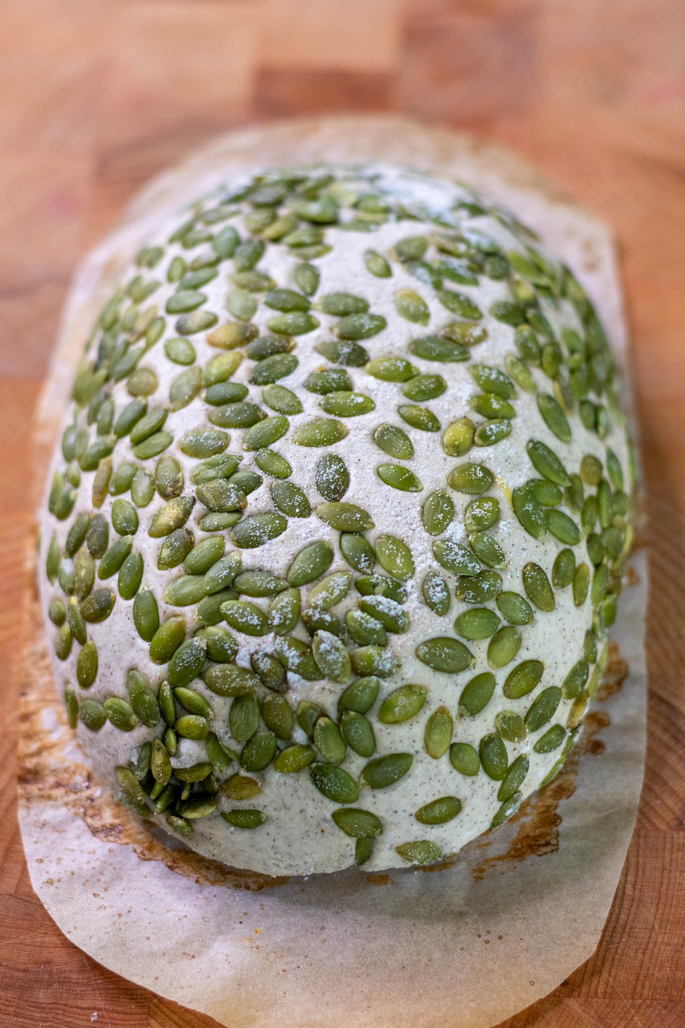 Buckwheat sourdough with pumpkin seeds turned out on parchment paper