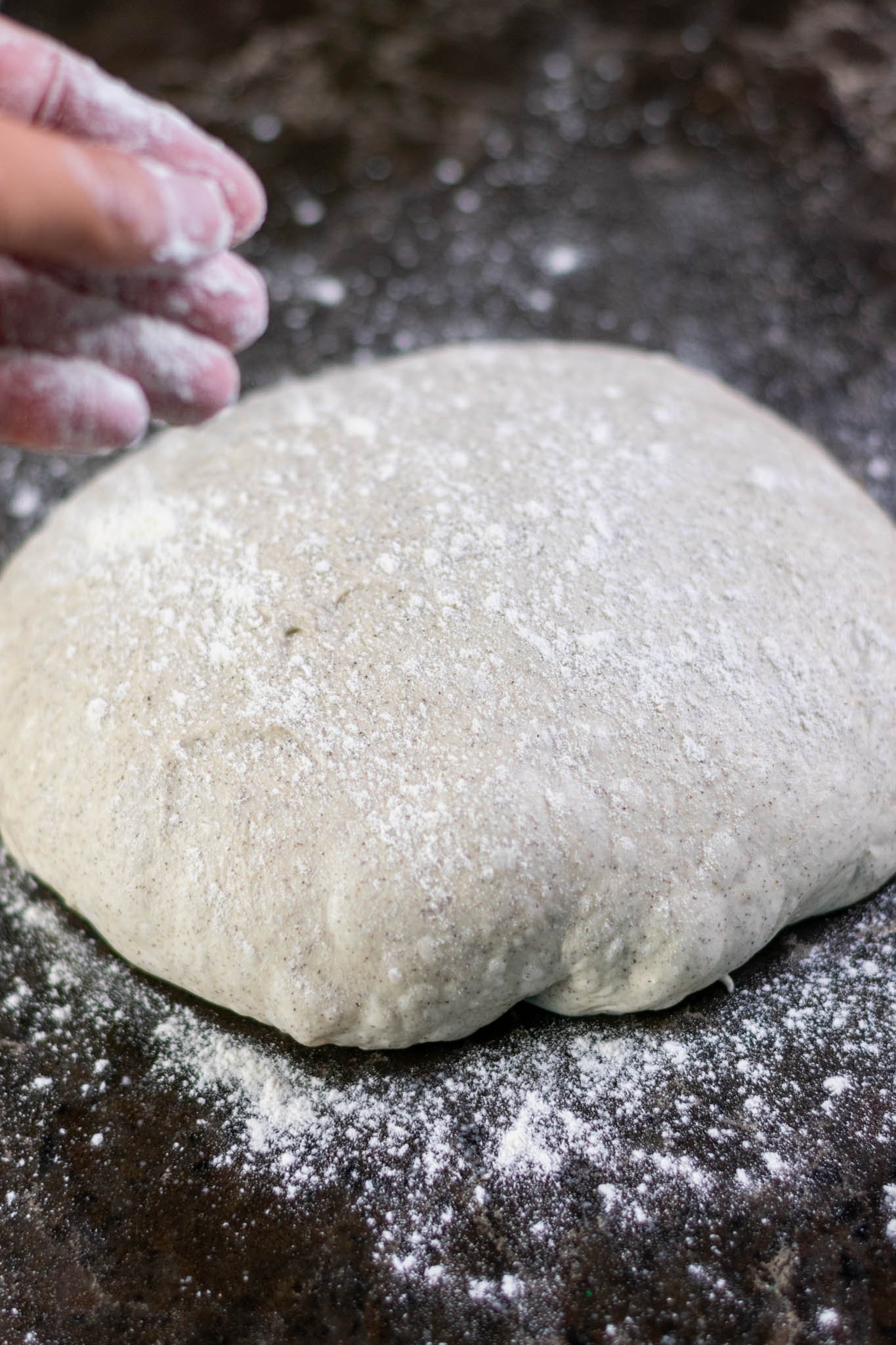 Dusting flour on preshaped dough