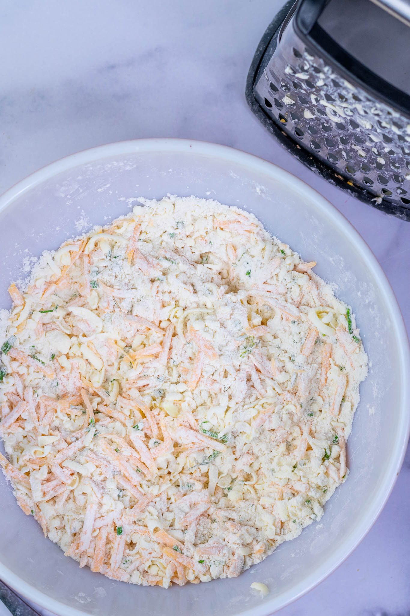 Mixed grated butter distributed into biscuit dough