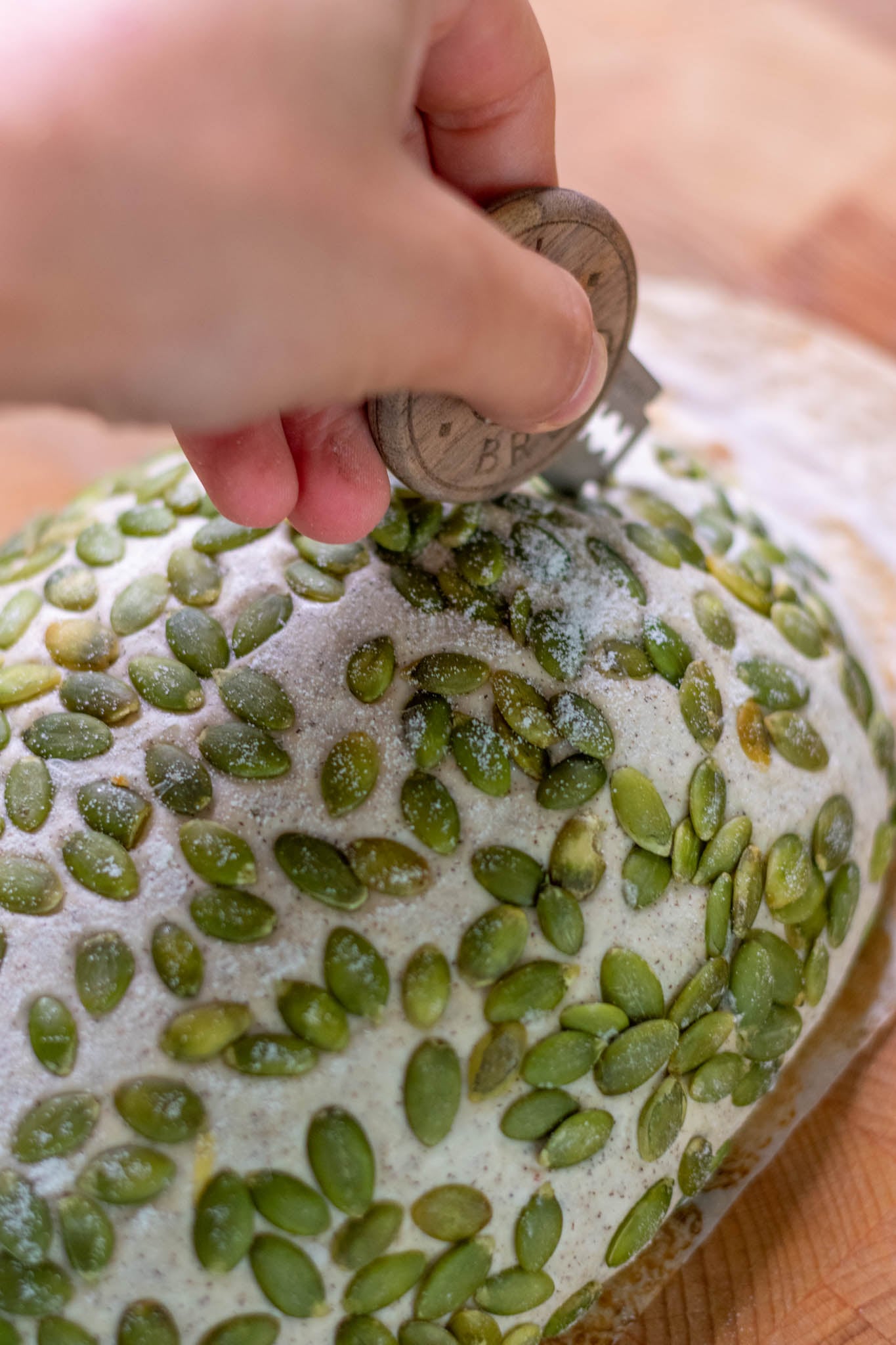 Scoring buckwheat sourdough with bread lame