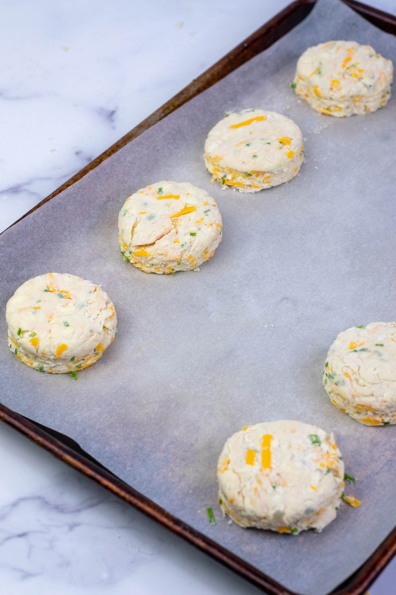 Sourdough biscuits on sheet pan before baking