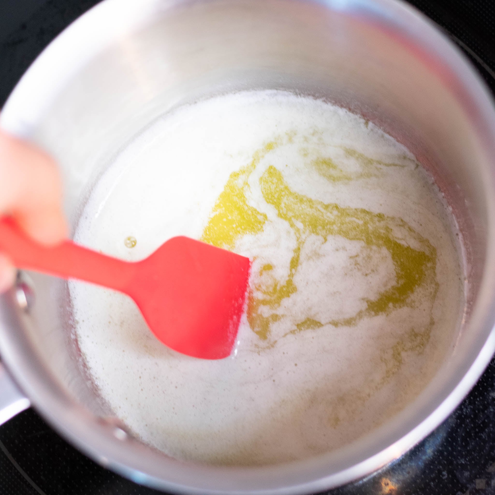 Spatula stirring melted butter in a saucepan