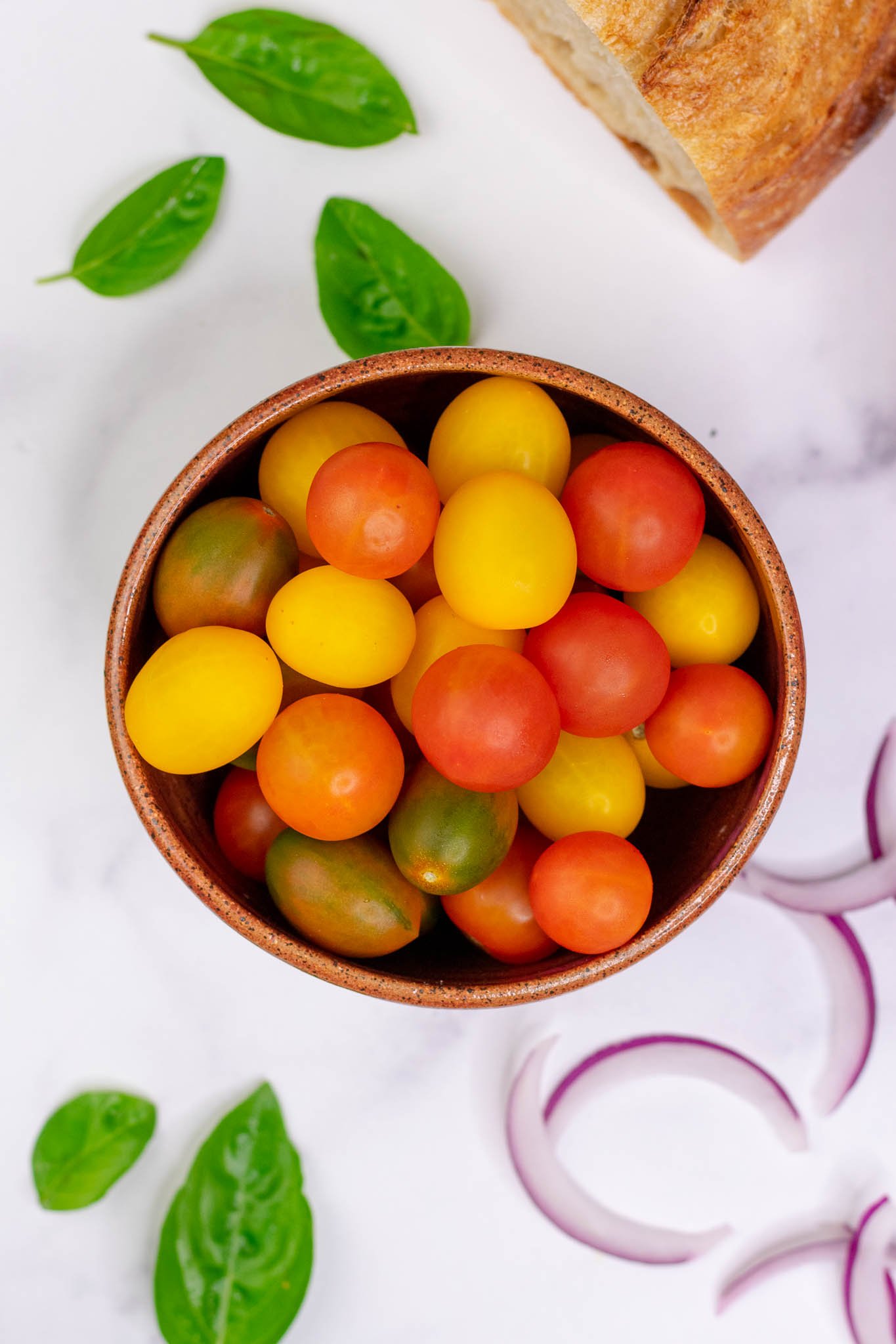 Bowl of cherry tomatoes, basil, and red onion