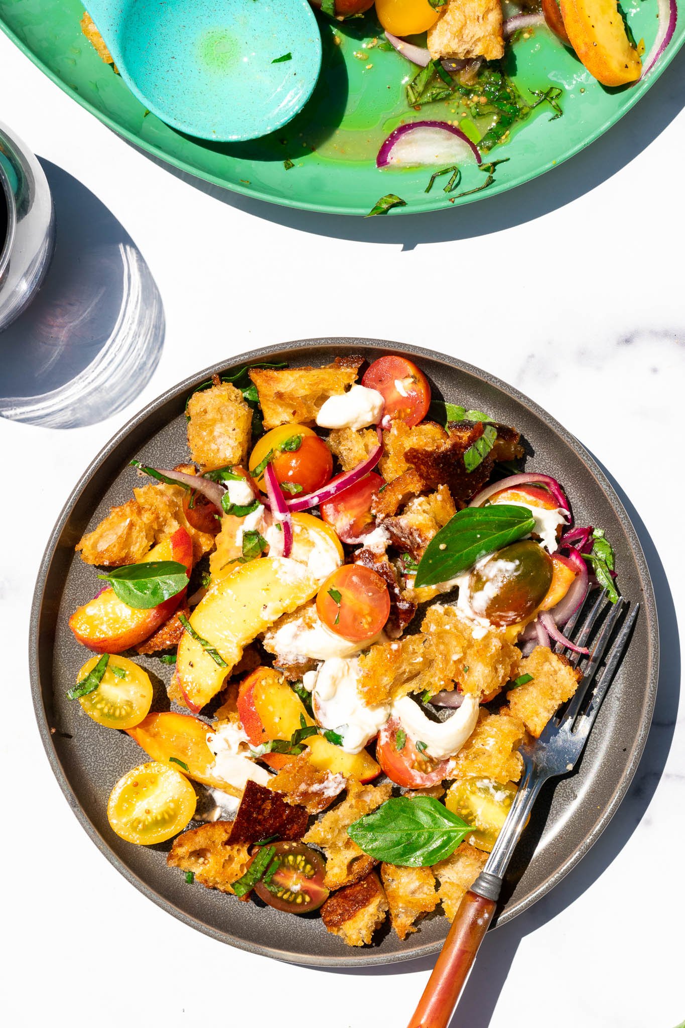 Sourdough panzanella with peaches and burrata on a plate