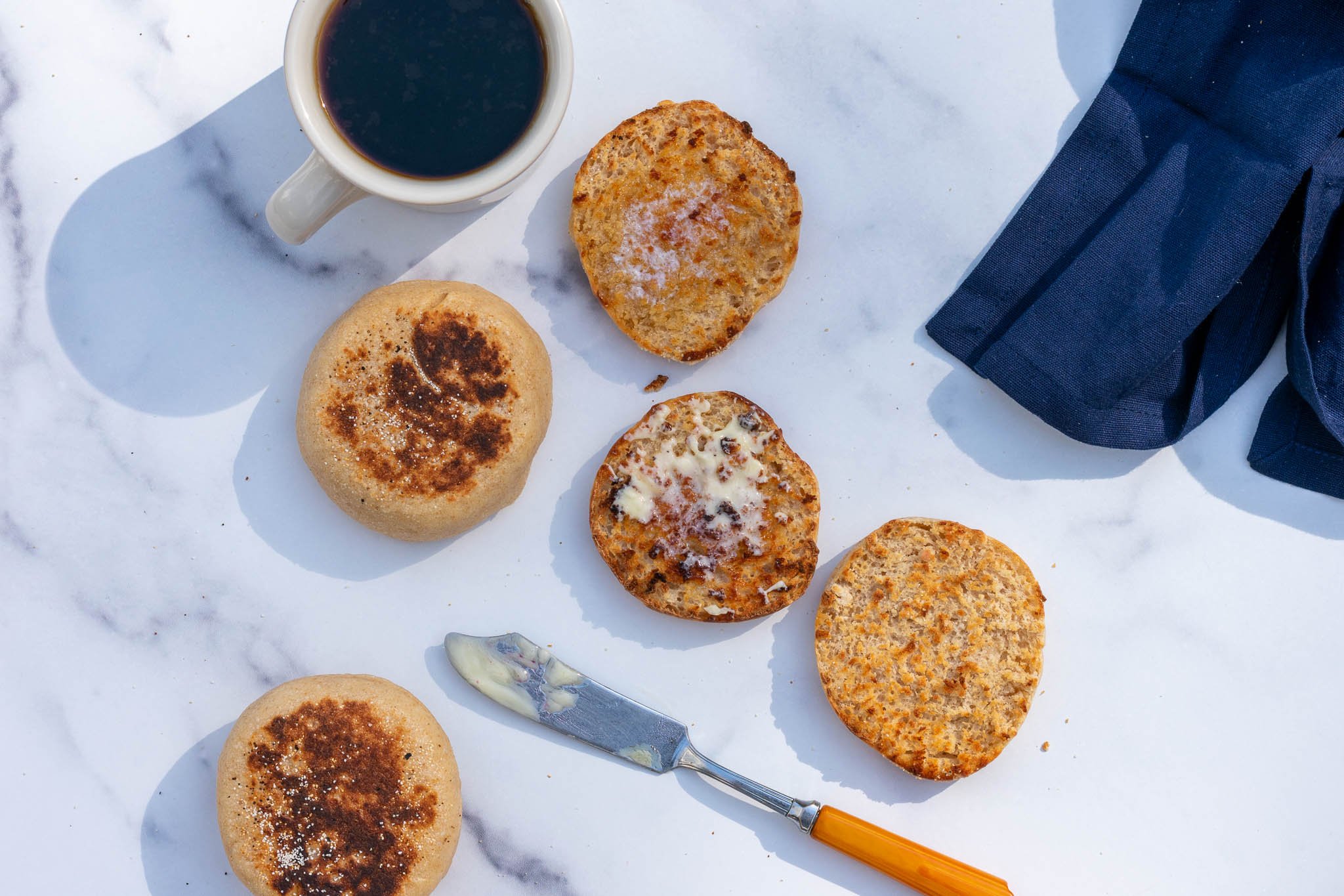 Sourdough English Muffins toasted and split with butter and coffee