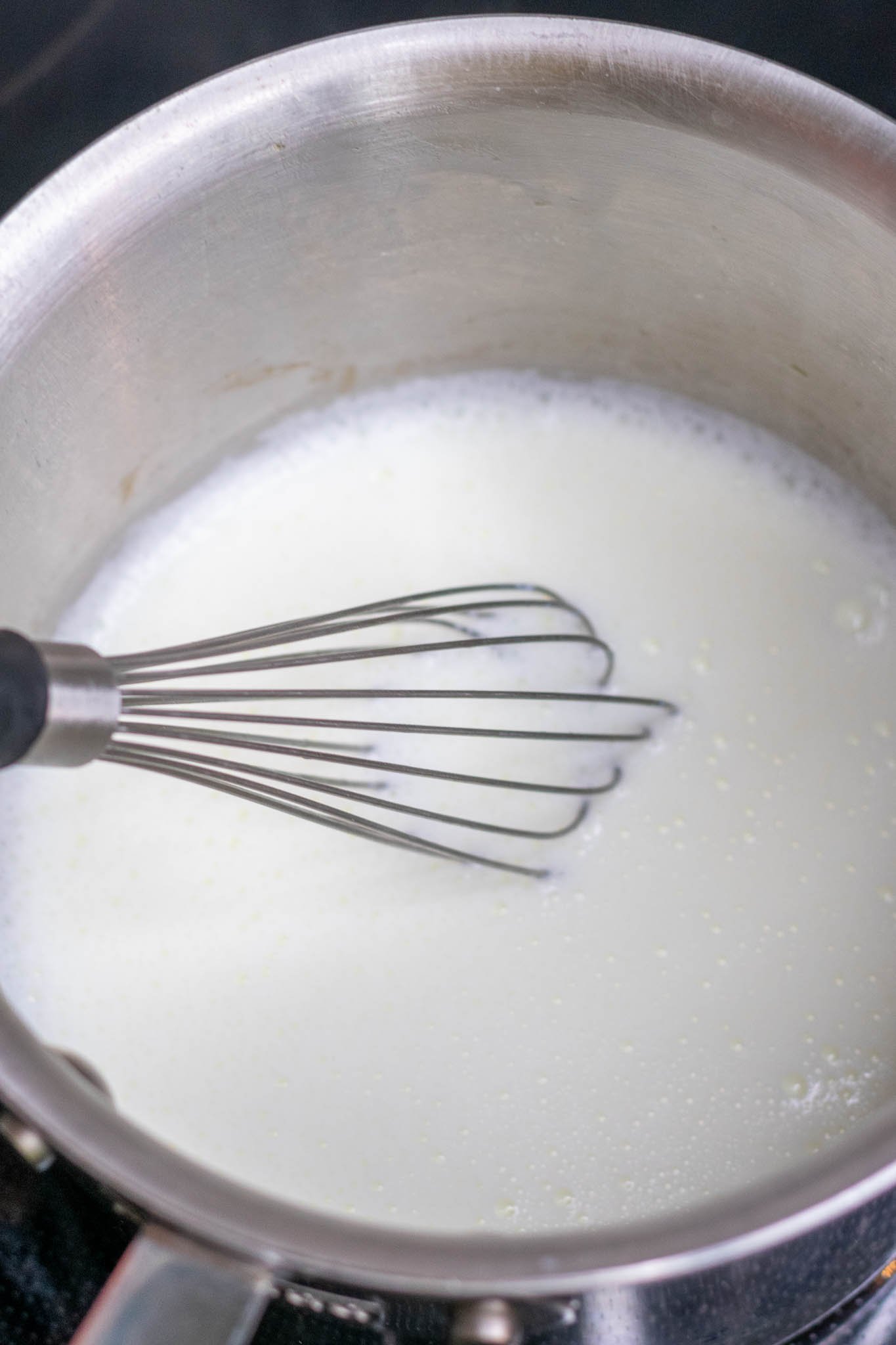 Whisking milk in sauce pan