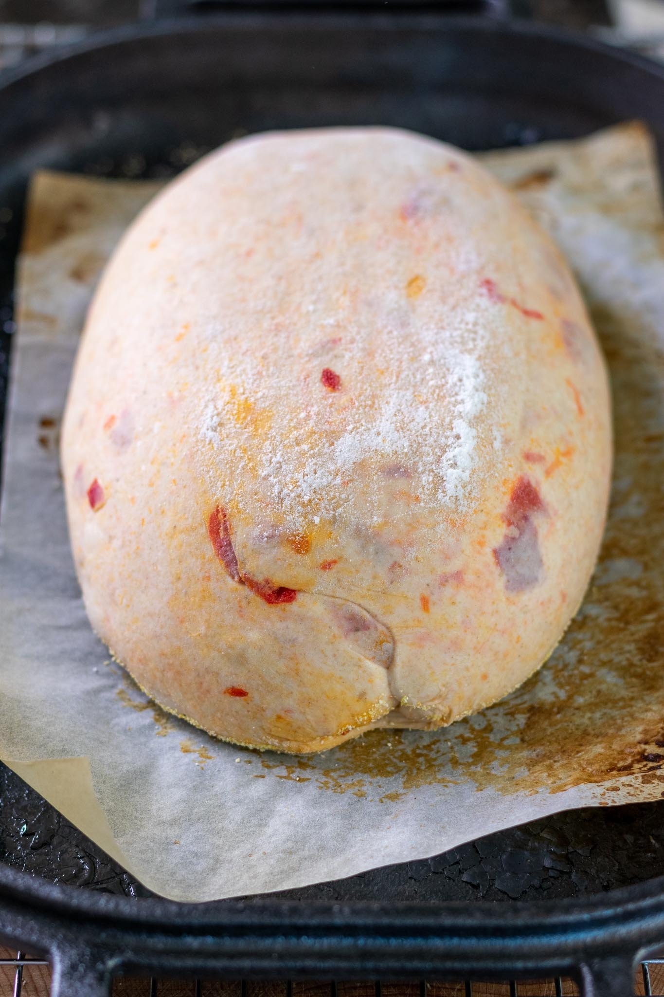 Calabrian chili sourdough on parchment paper before scoring