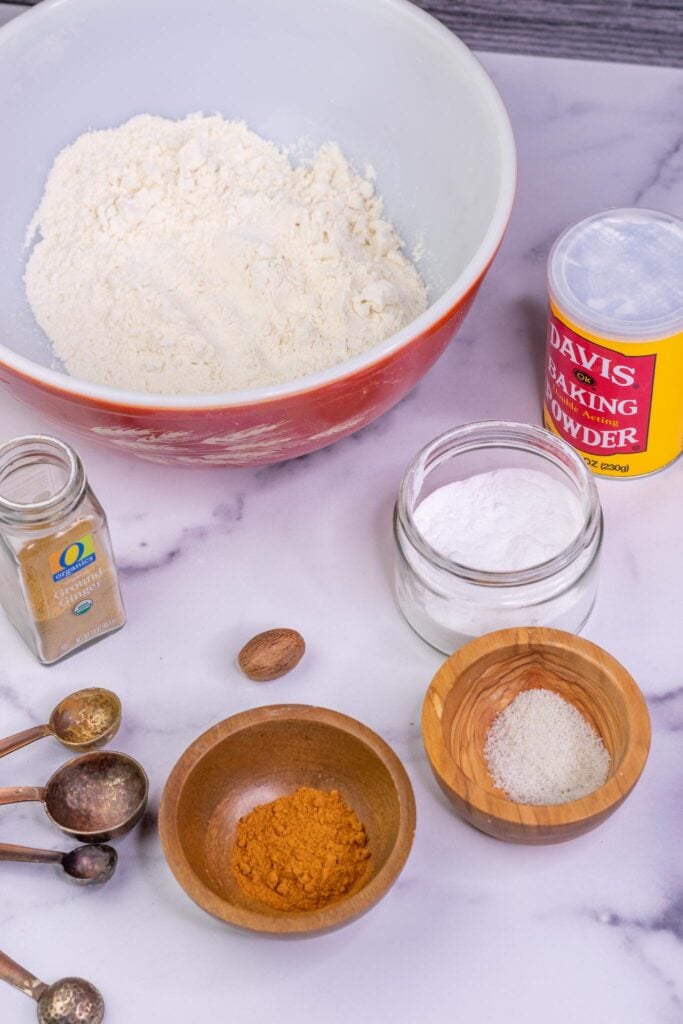Dry ingredients needed for Sourdough Pumpkin Waffles including flour, baking power, baking soda, pumpkin spices, and salt