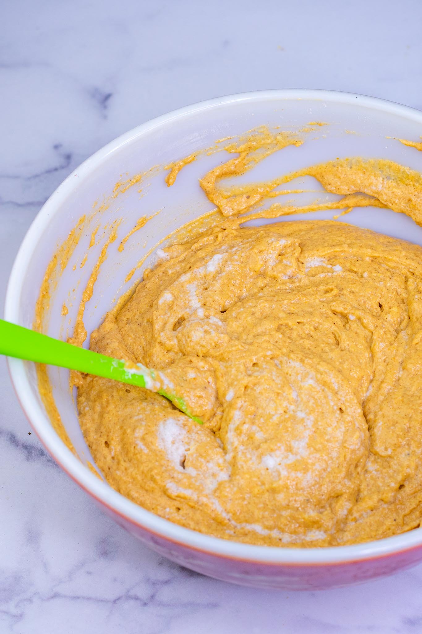 Mixed Sourdough Pumpkin Waffle batter in bowl and spatula