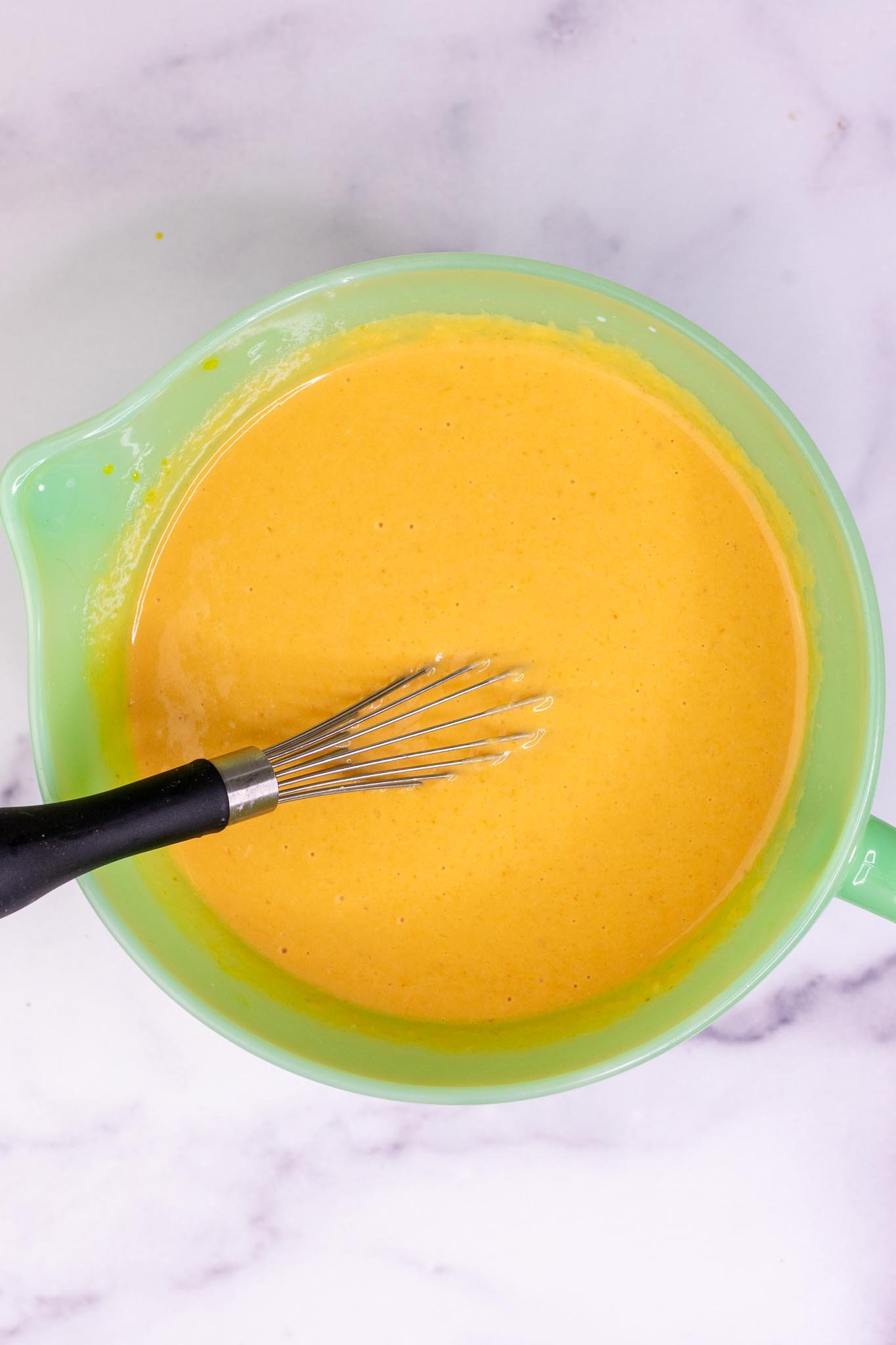 Mixed wet ingredients in bowl for Sourdough Pumpkin Waffles