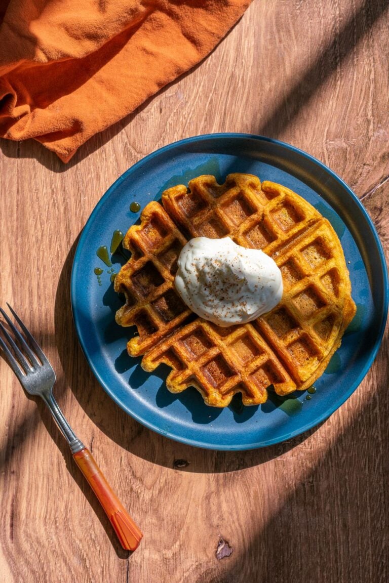 Plate of Sourdough Pumpkin Waffles with whipped cream