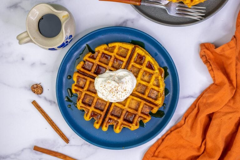 Sourdough Pumpkin Waffles with whipped cream, nutmeg, cinnamon, and maple syrup