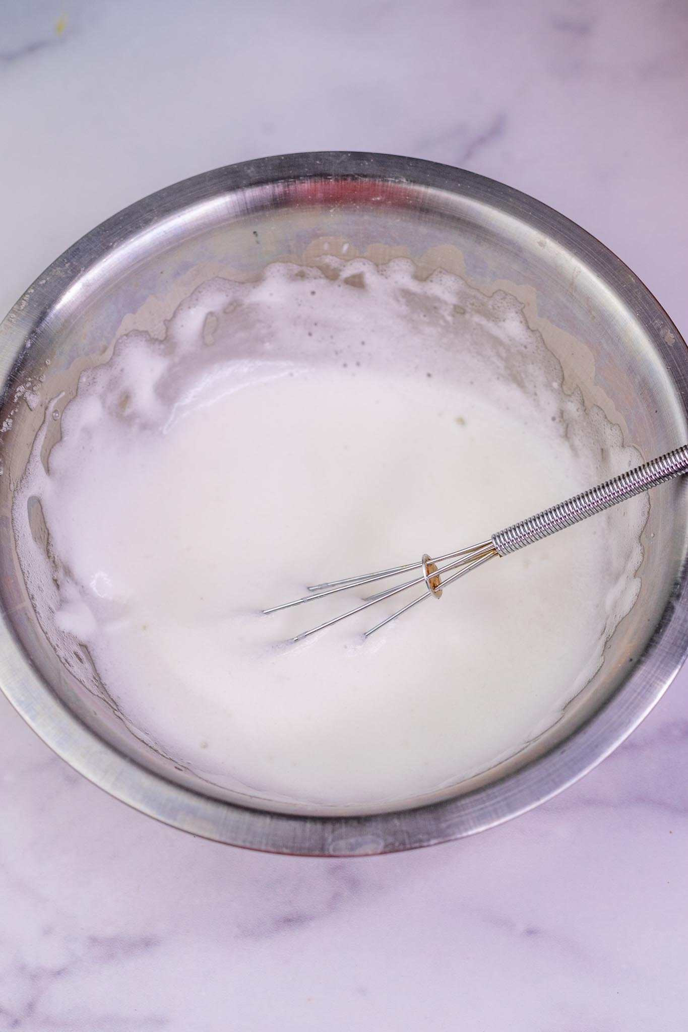 Whisked egg whites in bowl