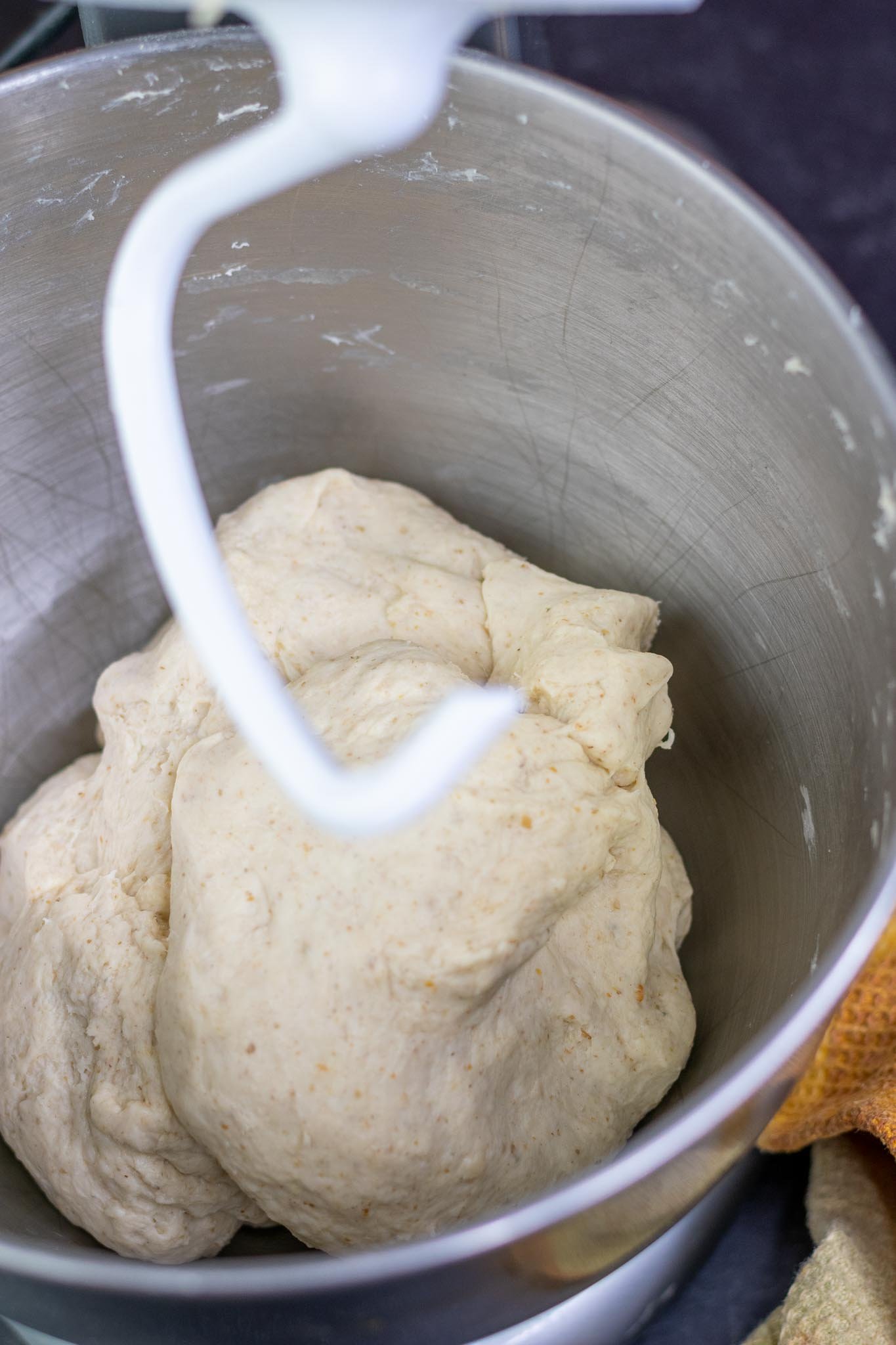 Mixed pretzel dough in mixing bowl with butter clear on sides