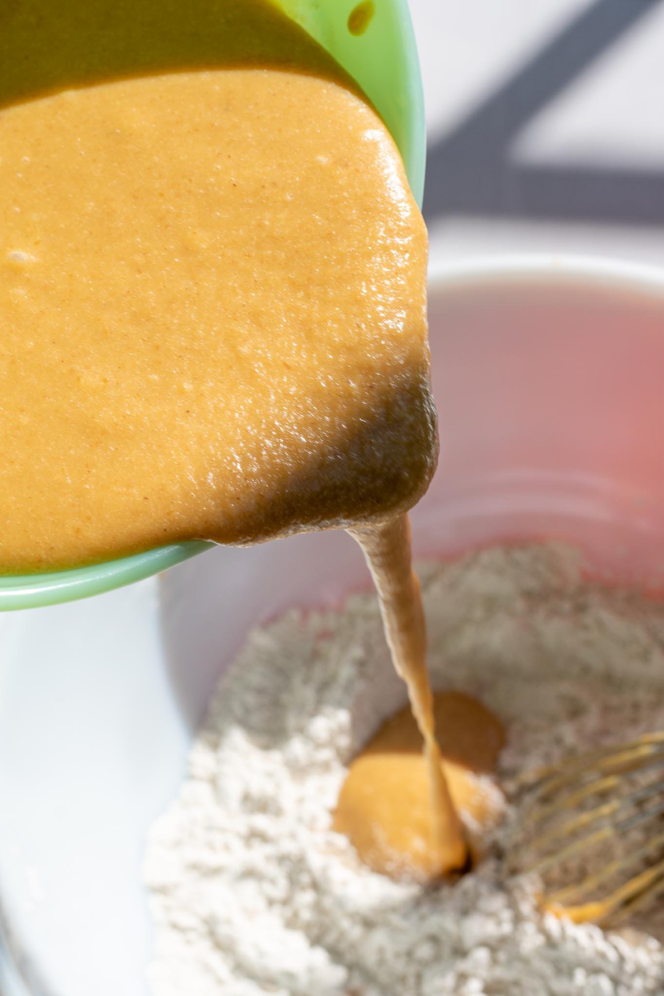 Pouring wet ingredients into dry ingredients