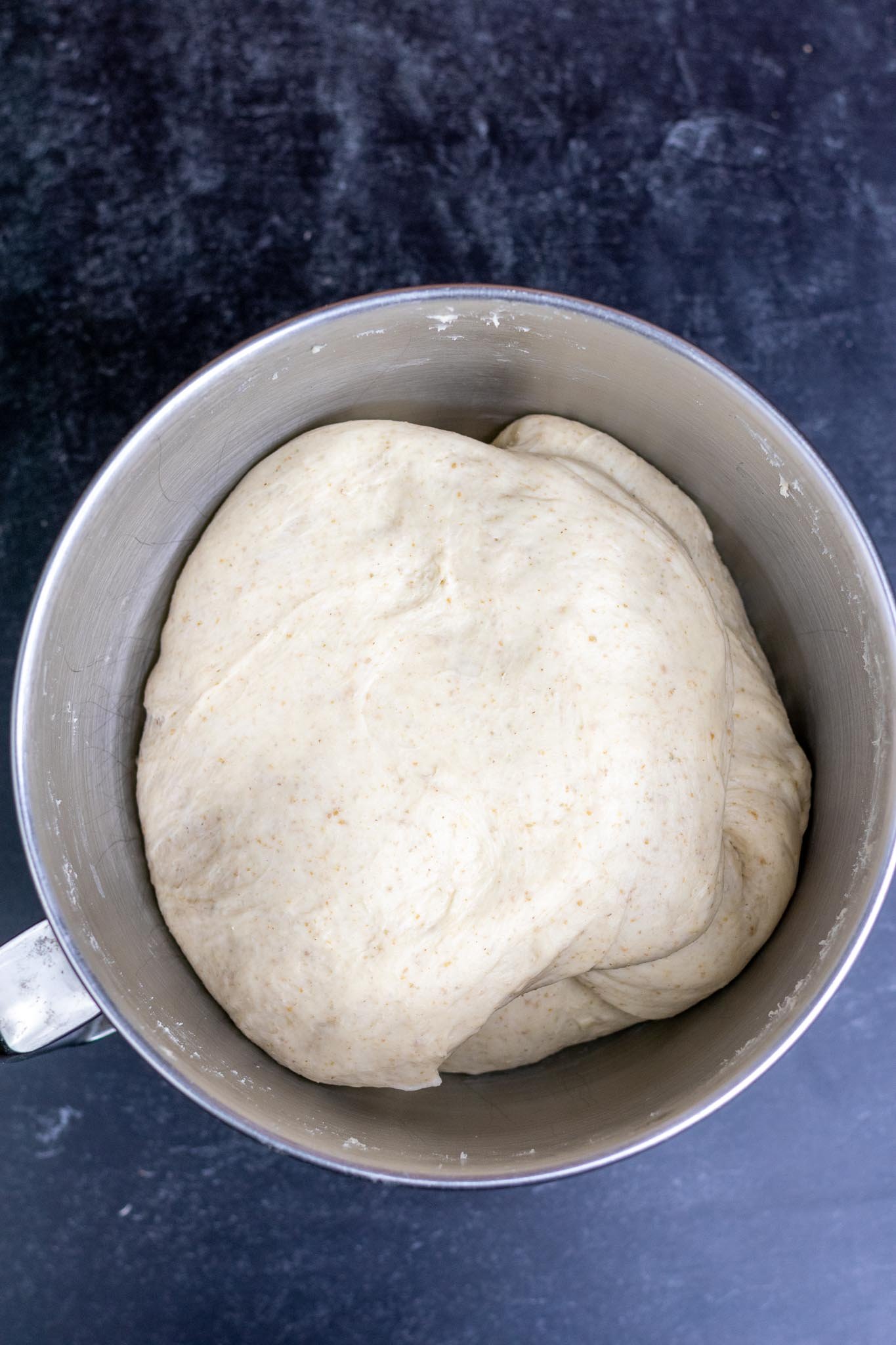 Sourdough pretzel dough in mixing bowl at the end of bulk fermentation