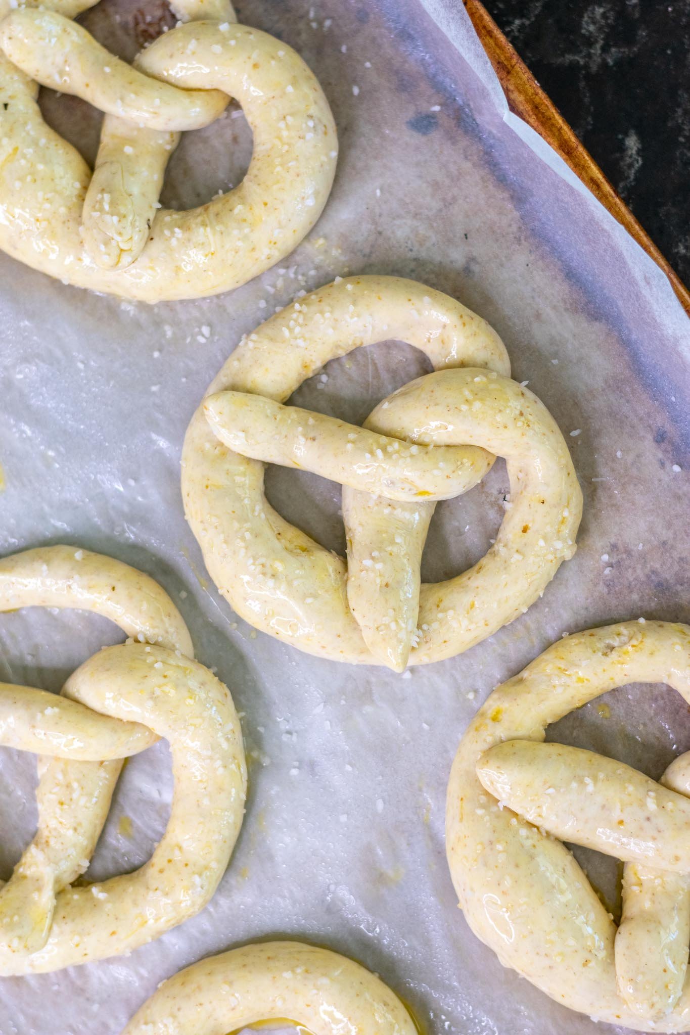 Sourdough pretzels with egg wash and pretzel salt before baking