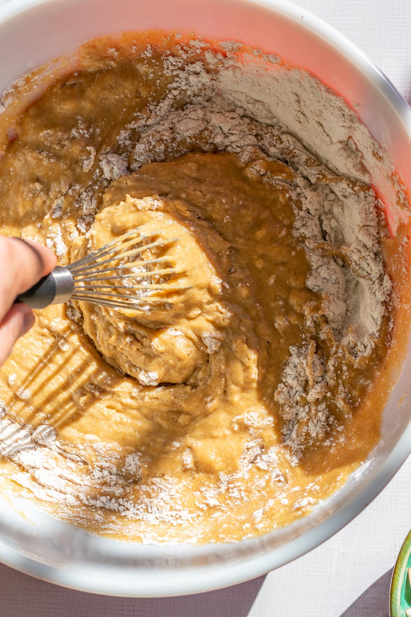 Stirring sourdough apple butter muffins batter
