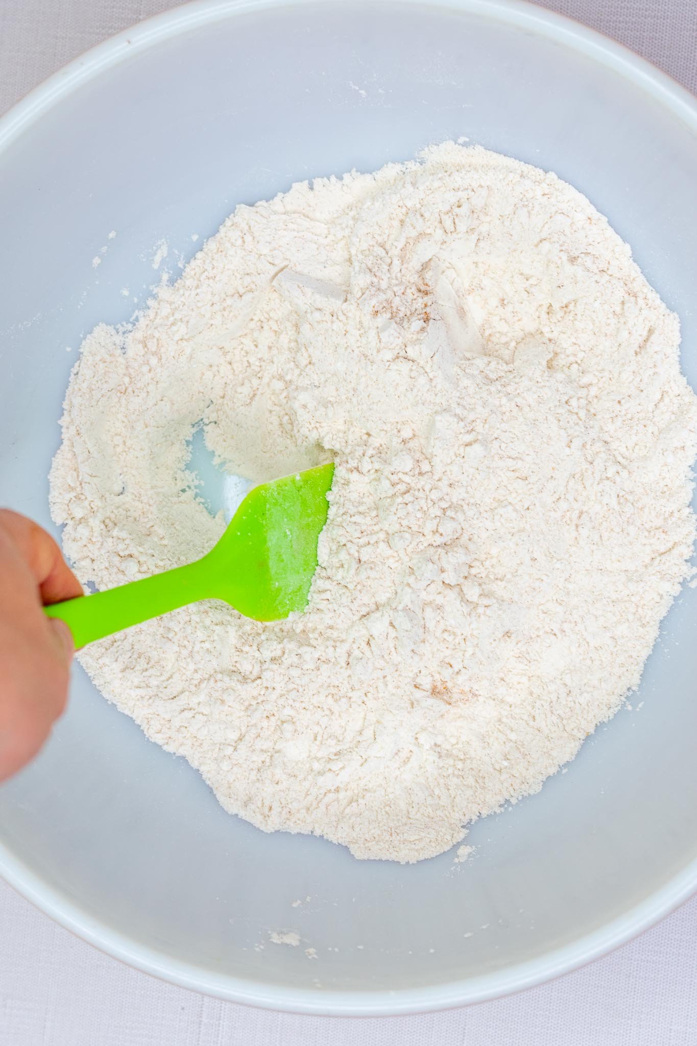Stirring dry ingredients for sourdough apple butter muffins