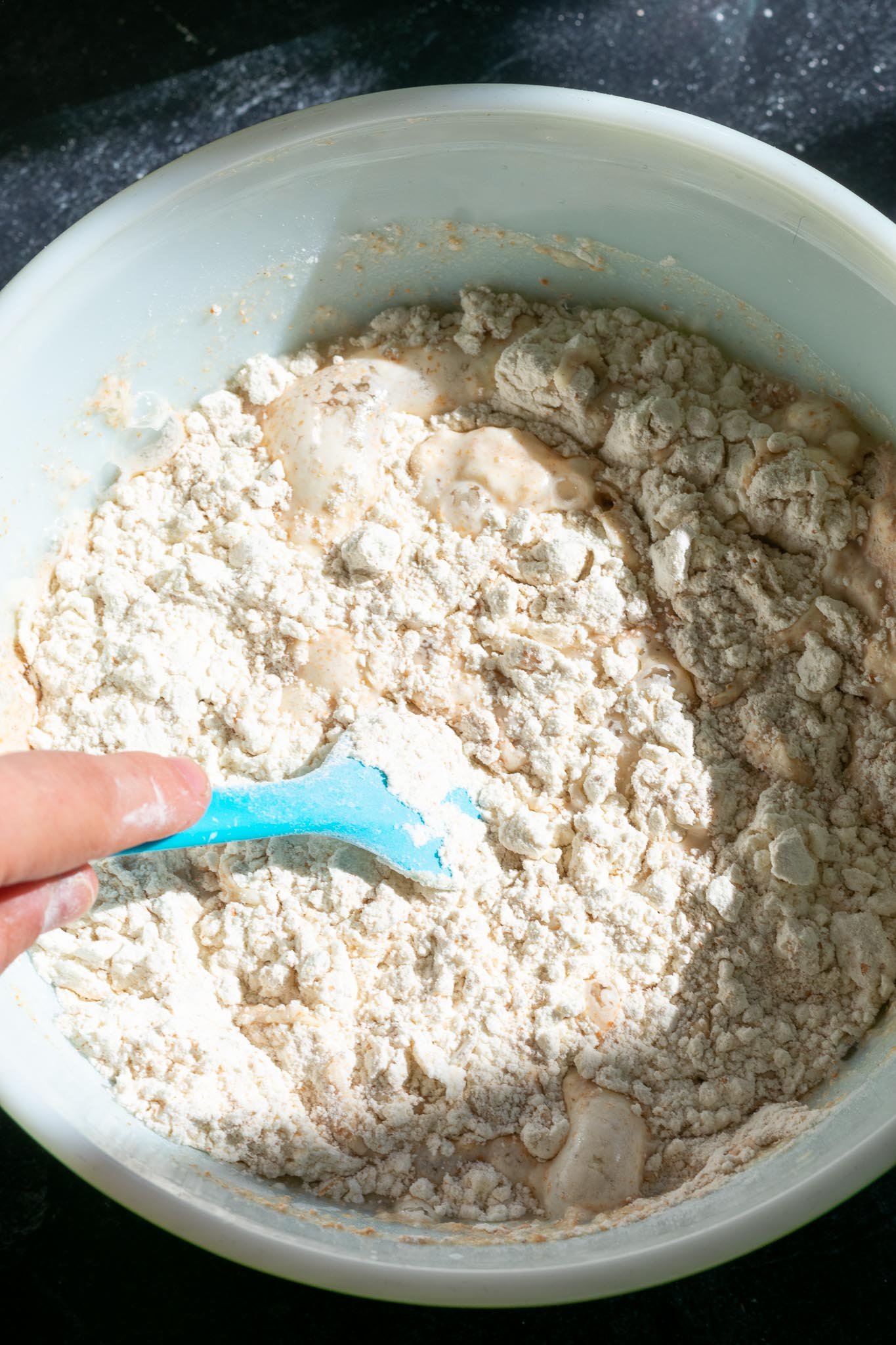 Mixing flour and water for autolyse in bowl
