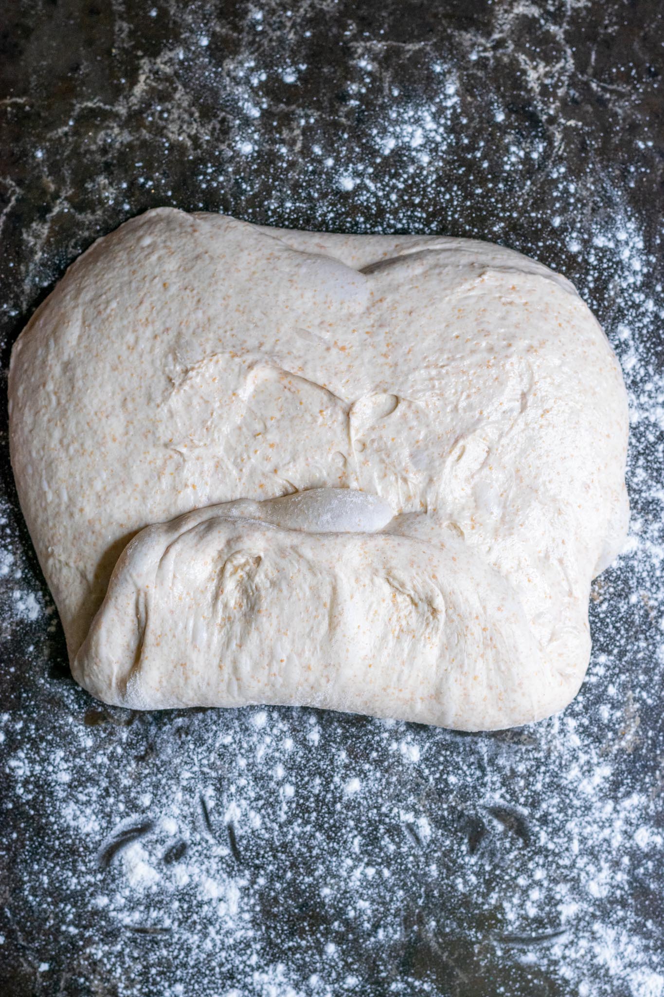 Folding dough into an envelop with bottom up ⅓