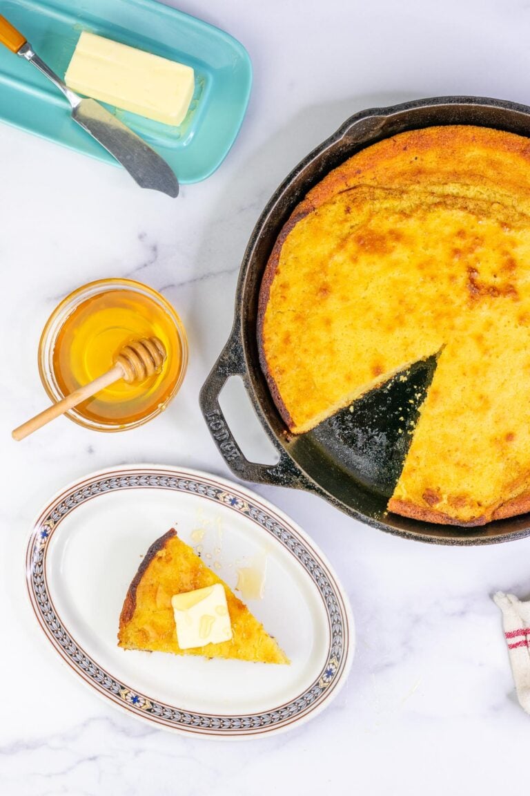 Sourdough Honey Cornbread in cast-iron skillet with butter