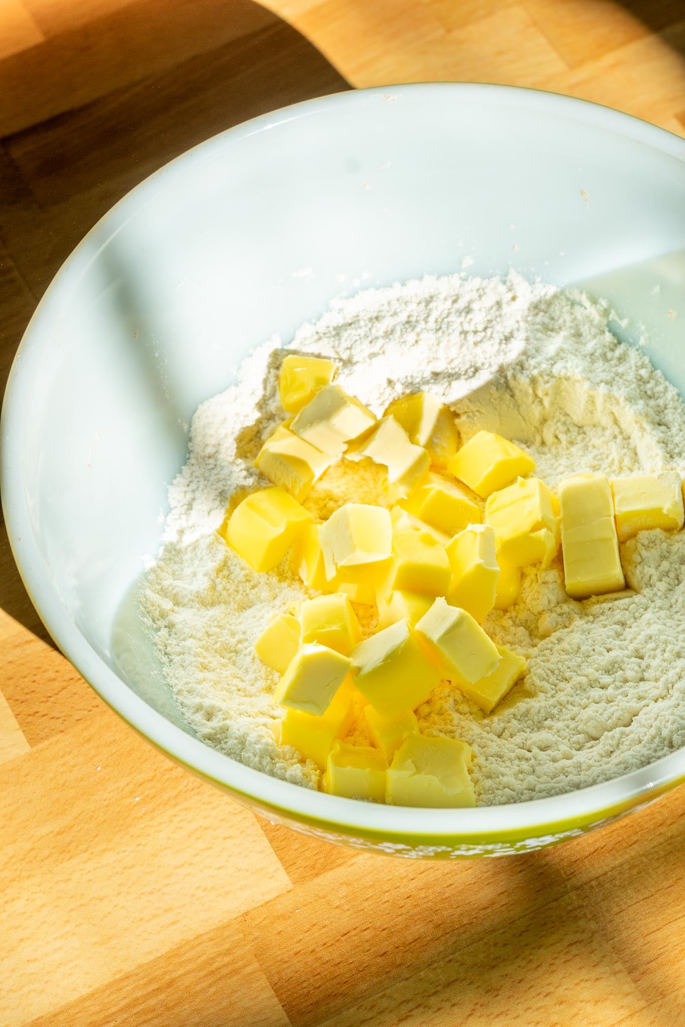 Cubed butter added to mixing bowl